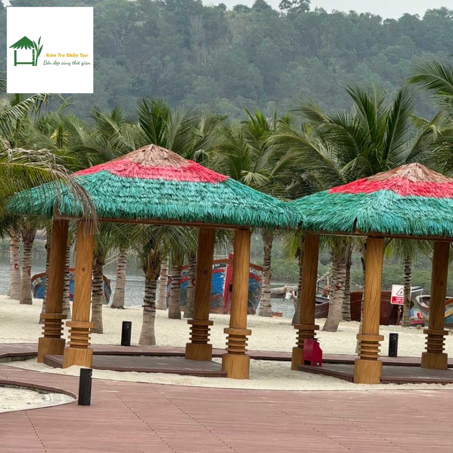 Cụm chòi lợp mái rơm nhân tạo đỏ – xanh trong khuôn viên resort.