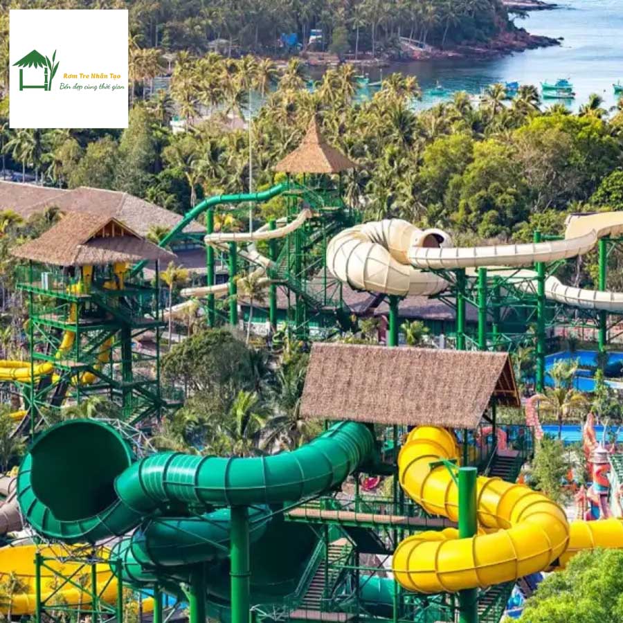 Cận cảnh máng trượt xanh uốn lượn tại Sun World Hòn Thơm với mái rơm nhân tạo trên chòi nghỉ.